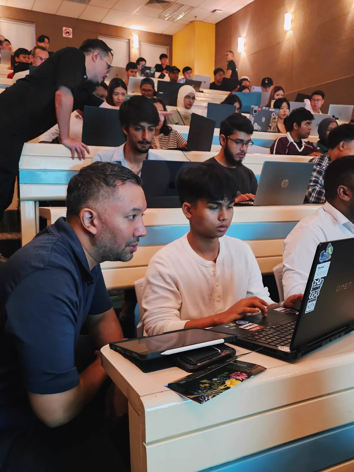 Students working with laptops during the Sunway University session.